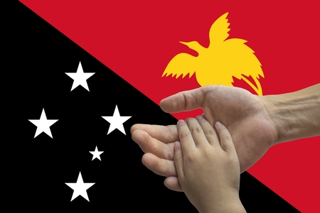 Flag of Papua New Guinea, intergration of a multicultural group of young people.の写真素材