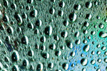 Macro of water drops on multicolor background.の写真素材