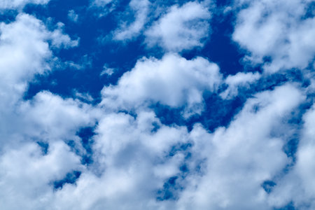 white fluffy clouds in the blue sky.