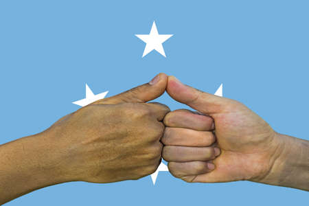 Flag of the Federated States of Micronesia, integration of a multicultural group of young people.の写真素材