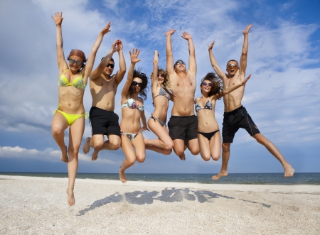 Joyful team of friends having fun at the beach の写真素材