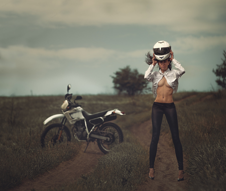 Biker girl next to a motorcycleの写真素材