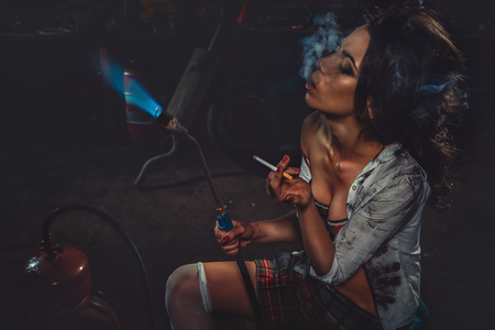 Smoking Girl with blowpipeの写真素材