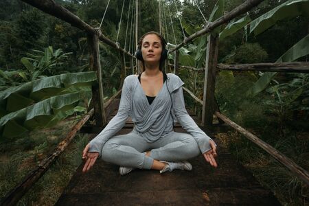 Yoga woman listens to the music