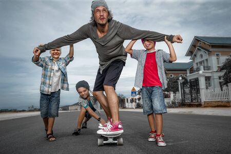 Father learning to ride skateboard