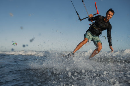 A kite surfer rides the waves