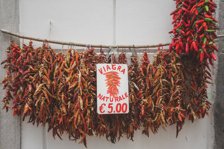 Hanging bundles of red hot peppers at a local farmers market, Spainの写真素材