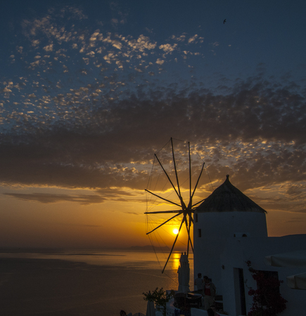 Sunset and windmill on the Island of Santorini, Greeceの写真素材