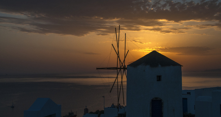 Sunset and windmill on the Island of Santorini, Greeceの写真素材