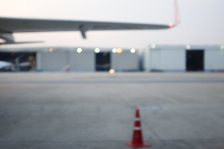 Blur Parked aircraft near the hangar. Cargo plane on the airfield. Commercial air freight. Sunset spotting at the airport.の写真素材