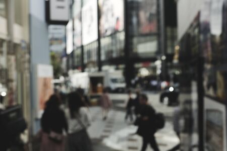 Blur People walking at footpath in  lunch time with light bokeh
Crowded street in Japan, blurred background in japan 
for background usage.の写真素材