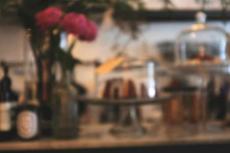 Blurred background image of modern coffee shop. abstract blur background with people in cafe. warm color tone styleの写真素材