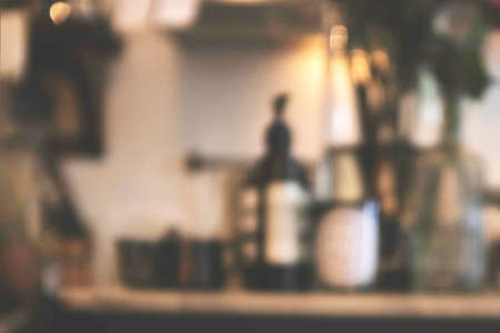 Blurred background image of modern coffee shop. abstract blur background with people in cafe. warm...