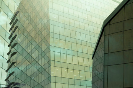 Highrise glass building with sky and clouds reflection. geometric shapes and buildings
