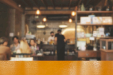 Blur coffee shop or cafe restaurant with abstract bokeh light image background. People in store Blur...