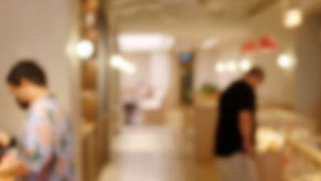 Blur coffee shop interior background - can used for display or montage your products.barista in...