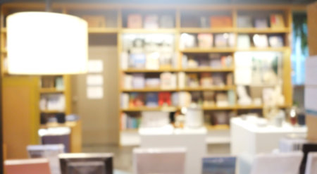 Blur background of book shelf store decorated with wood and warm light.の写真素材