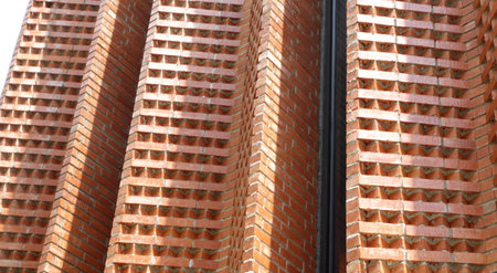 Abstract Brick of looking up at modern facade and concrete building. Architectural exterior detail of  building.の写真素材