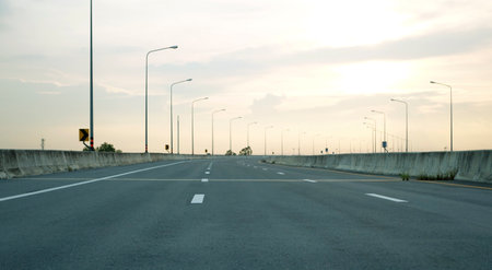 Panoramic city skyline and mountain with empty asphalt road at sunsetの写真素材