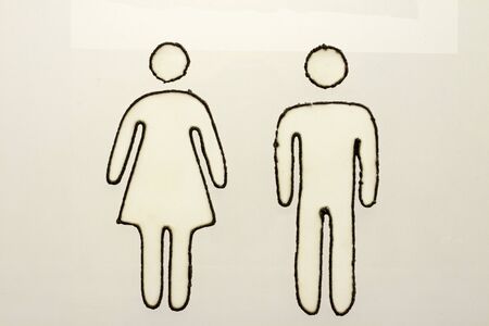 Drawing of a man and woman placed on the toilet door.の写真素材