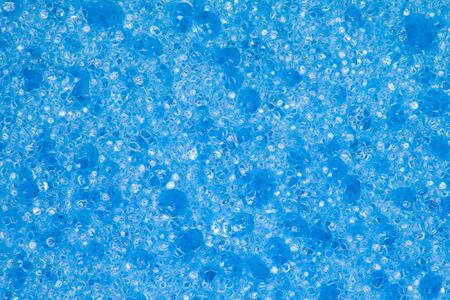 Kitchen sponge in blue color used mainly for washing dishes, in close-up shot.