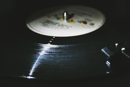 Moody image of a vintage vinyl record being playedの写真素材