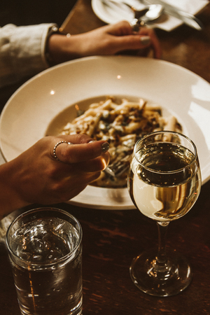 Person eats a fancy pasta in a nice restaurantの写真素材
