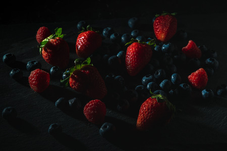 Moody berries in dark food photographyの写真素材