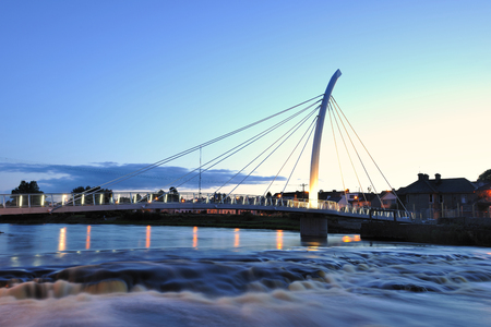 River Moy at Ballina, Co.Mayo, Ireland, with pedestrian bridge, part of which is  shaped to resemble...