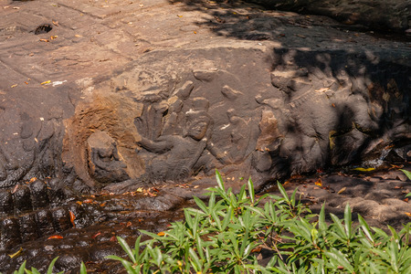 Lord Vishnu lying on the serpent god Ananta, with Goddess Lakshmi at his feet and Lord Brahma on a lotus petal, in Kbal Spean River bankの写真素材