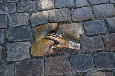 A bronze relief of a hand caressing a female breast on Oudekerksplein, Amsterdamのeditorial素材