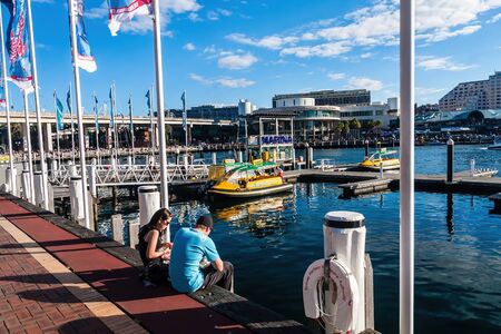 Darling Harbour and water taxis at the marina on a sunny day, Sydneyの写真素材