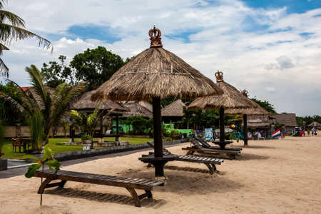 A beach with shelters in the traditional Balinese style, Bali, Indonesiaのeditorial素材