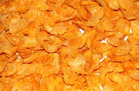 Yellow corn flakes on the white surface