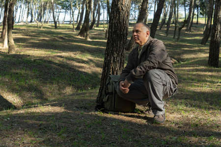 Mature man resting in the woodの写真素材