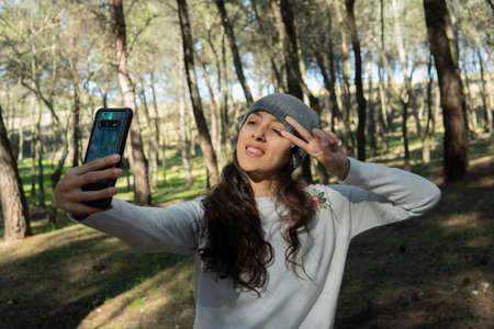 Young woman talking on the phone in the nature