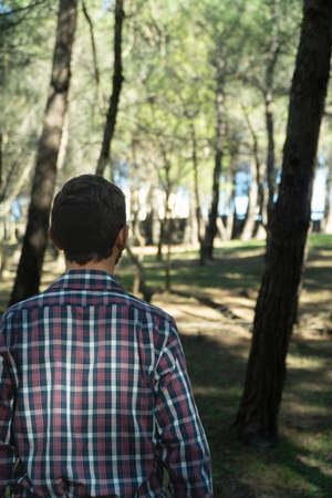 Back of a young latin man during a trekking dayの写真素材