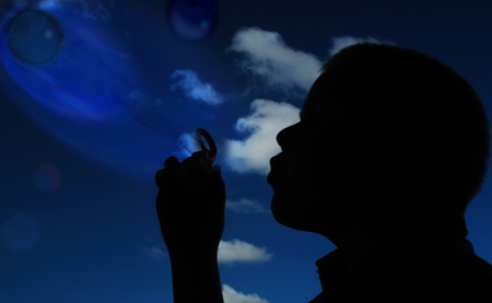 silhouette child blowing bubblesの写真素材