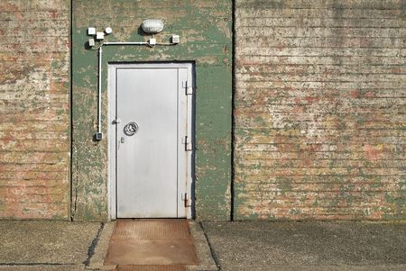 entrance of a forsaken bunker with steel doorの写真素材
