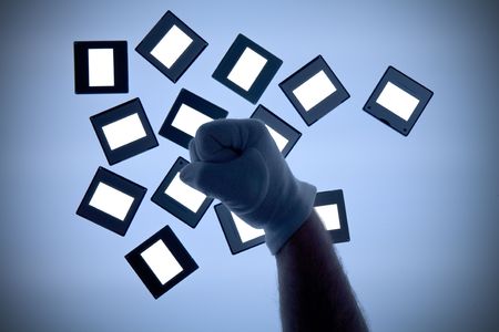  slides on a light table, free copy space, with gloved handの写真素材