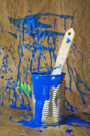 Paint can with brush and blue paintsplatters,against grungy backgroundの写真素材