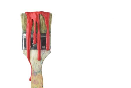 Paint brush with red color drops, isolated on white backgroundの写真素材
