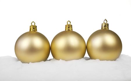 Snow covered Christmas Balls in a row, isolated on white backgroundの写真素材