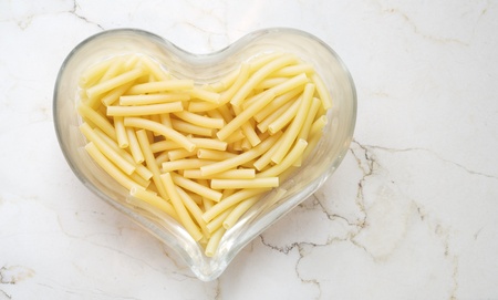 Italian noodle,  pasta macaroni, in a heart shaped glass bowl