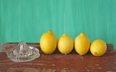 lemons and a retro lemon squeezer, free copy spaceの写真素材