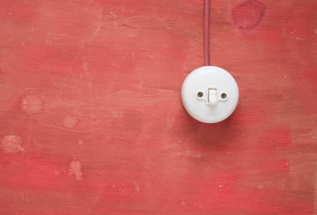 vintage electrical swtich on red wall, free copy space