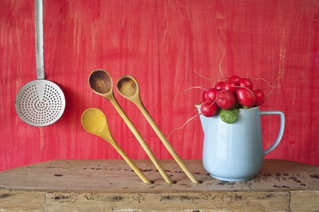 bunch of radish in a blue mug,kitchen utensilsの写真素材