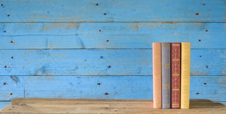 row of books, grungy blue background, free copy space の写真素材