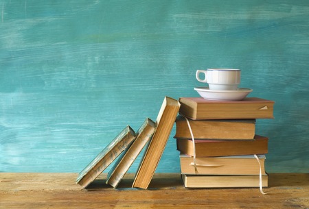 vintage books with coffee cup, grungy background, free copy space の写真素材