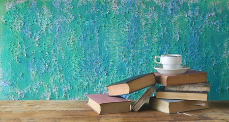 vintage books with a cup of coffee, grungy background, free copy space の写真素材